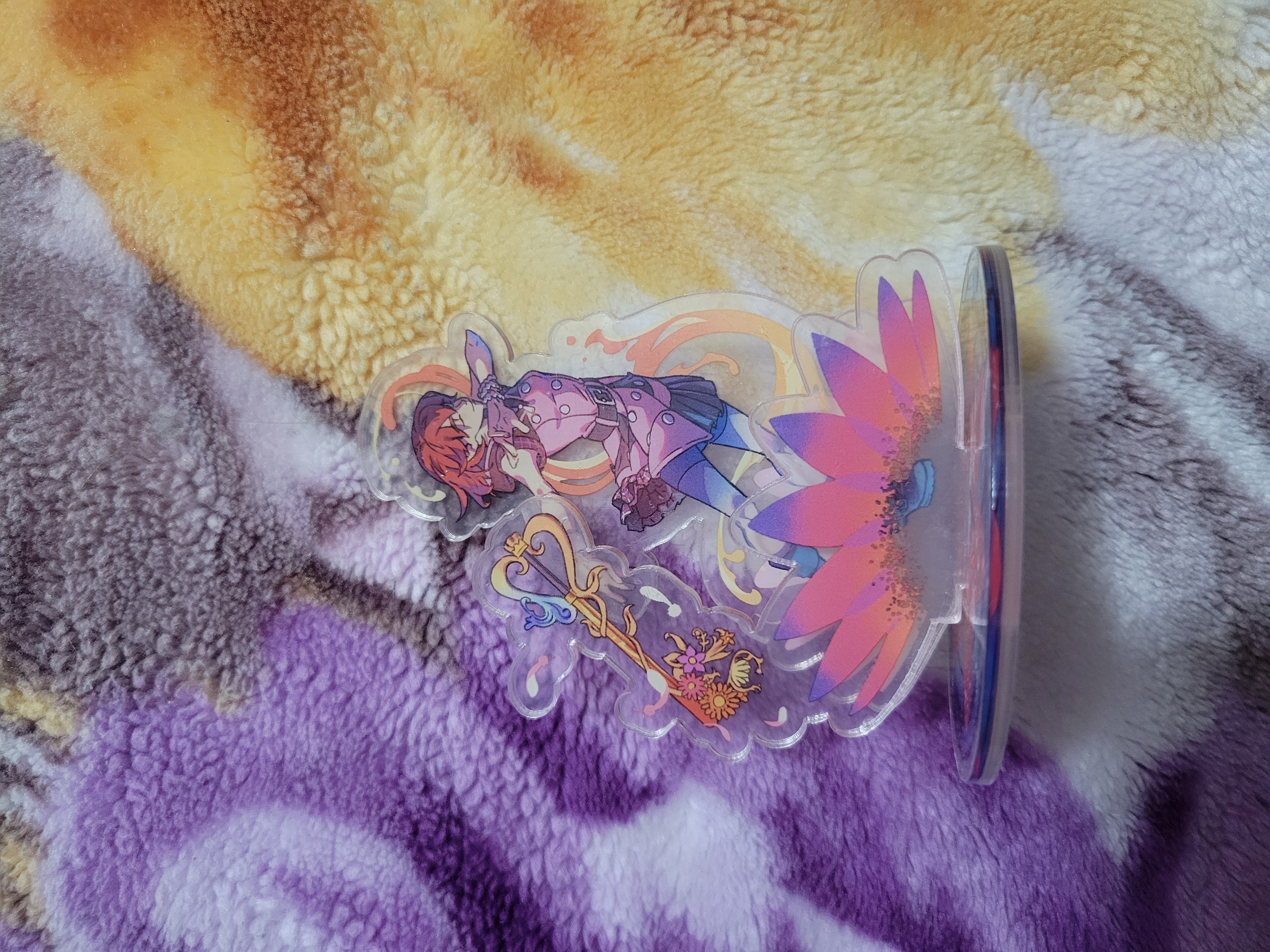 Three piece acrylic standee of Kairi summoning a spell as her keyblade floats aside her. There is a magical flower under her feet.